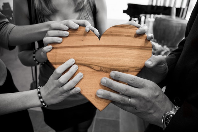 people holding heart together